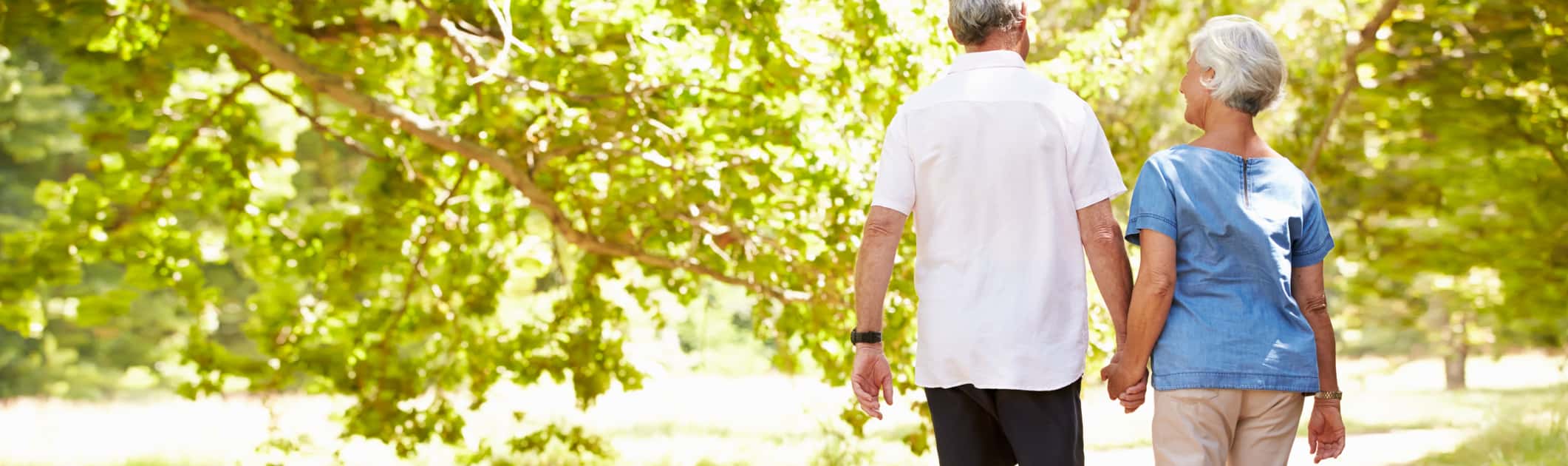 A senior couple walking together in the countryside